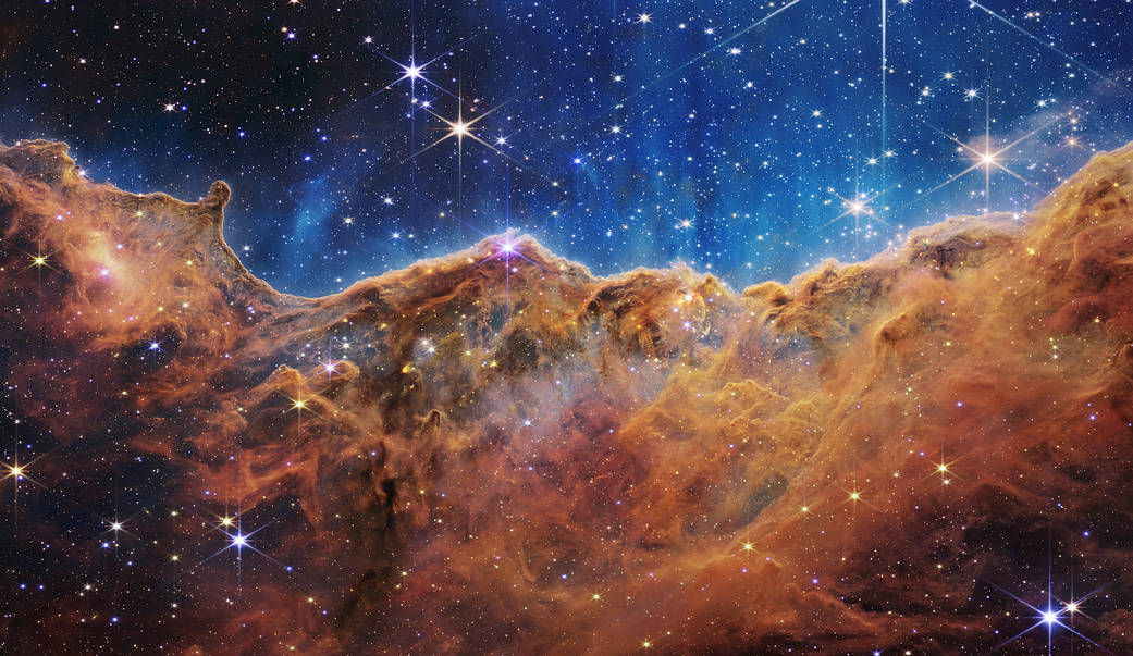 An image created by NASA’s James Webb 
                        Space Telescope revealing emerging stellar nurseries and individual stars in the 
                        Carina Nebula.